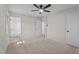 A carpeted bedroom with a ceiling fan, leading to a bathroom and hallway at 208 Essex Rd, Nashville, NC 27856