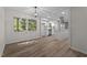 Open dining room with modern flooring, new paint, chandelier, and an adjoining view into the bright kitchen at 208 Essex Rd, Nashville, NC 27856