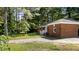 Single story brick house with a vibrant lawn and traditional white porch railing at 208 Essex Rd, Nashville, NC 27856