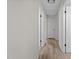 Hallway view with wood-look flooring and white doors at 208 Essex Rd, Nashville, NC 27856
