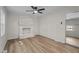 Bright living room featuring a white brick fireplace and modern ceiling fan at 208 Essex Rd, Nashville, NC 27856