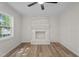 Bright living room featuring a white brick fireplace and modern ceiling fan at 208 Essex Rd, Nashville, NC 27856
