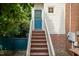 White two story home with a bright blue back entrance door and wood stairs at 2236 The Cir, Raleigh, NC 27608