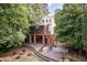A spacious backyard featuring a screened in porch, outdoor seating, and a fire pit area at 2236 The Cir, Raleigh, NC 27608