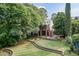 Spacious backyard featuring mature trees, an outdoor seating area, and a fire pit at 2236 The Cir, Raleigh, NC 27608