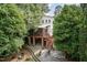 Aerial view of a home's backyard with a screened porch, outdoor seating, and a fire pit at 2236 The Cir, Raleigh, NC 27608