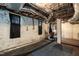 A basement with white-painted brick walls, two black windows, and exposed ceiling ductwork and piping at 2236 The Cir, Raleigh, NC 27608