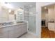 Bathroom featuring dual sinks, granite countertop, and a glass-enclosed shower at 2236 The Cir, Raleigh, NC 27608