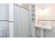 Bright bathroom featuring a pedestal sink, shelves, and a patterned shower curtain at 2236 The Cir, Raleigh, NC 27608