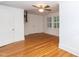 Bright bedroom featuring beautiful wood flooring and large windows with shutters at 2236 The Cir, Raleigh, NC 27608
