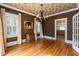 Charming dining room with hardwood floors, a vintage chandelier, and access to kitchen at 2236 The Cir, Raleigh, NC 27608