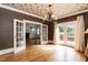 Elegant dining room with hardwood floors, chandelier, and access to living room and patio at 2236 The Cir, Raleigh, NC 27608