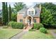 Brick home with manicured landscaping, lovely walkway, and cozy covered front entrance at 2236 The Cir, Raleigh, NC 27608