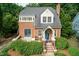 Brick home with manicured landscaping, walkway, cozy covered front entrance, and inviting curb appeal at 2236 The Cir, Raleigh, NC 27608