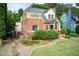 Charming brick home with blue door, landscaped front yard, and mature trees at 2236 The Cir, Raleigh, NC 27608