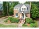 Classic brick home with a well-manicured lawn, lush bushes and cozy front porch at 2236 The Cir, Raleigh, NC 27608