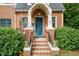 Close-up shot of the front door and entry way, featuring a brick facade at 2236 The Cir, Raleigh, NC 27608