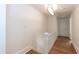 Well-lit hallway with hardwood flooring and classic architectural details at 2236 The Cir, Raleigh, NC 27608