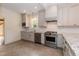 Well-lit kitchen featuring stainless steel appliances, gray cabinets, and tile flooring at 2236 The Cir, Raleigh, NC 27608