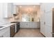 Spacious kitchen featuring stainless steel appliances, gray cabinets, and open layout at 2236 The Cir, Raleigh, NC 27608