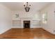 Bright living room featuring hardwood floors, a fireplace, and built-in shelving at 2236 The Cir, Raleigh, NC 27608