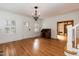 Bright living room with hardwood floors, a fireplace, and a classic chandelier at 2236 The Cir, Raleigh, NC 27608