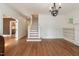Spacious living room with hardwood floors, staircase, chandelier, and natural light at 2236 The Cir, Raleigh, NC 27608
