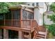 View of a charming screened porch with wood stairs and a finished outdoor area with brick column supports at 2236 The Cir, Raleigh, NC 27608