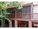 View from below of a screened porch, showing outdoor ceiling fans and brick supports at 2236 The Cir, Raleigh, NC 27608