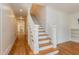 Elegant staircase with hardwood steps and white painted banister at 2236 The Cir, Raleigh, NC 27608