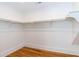 Spacious walk-in closet with shelving and hardwood floors at 2236 The Cir, Raleigh, NC 27608