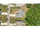 Overhead view displays a home's roof, driveway, and verdant lawn with adjacent greenery at 230 Paddy Ln, Youngsville, NC 27596