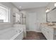 Bathroom featuring a soaking tub, walk-in shower, double vanity, and white cabinets at 230 Paddy Ln, Youngsville, NC 27596