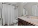 Bathroom features a shower and tub combo, vanity, and framed mirror at 230 Paddy Ln, Youngsville, NC 27596