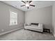Neutral bedroom features a plush sofa, window, and ceiling fan at 230 Paddy Ln, Youngsville, NC 27596