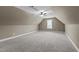 Large bonus room with neutral carpet, ceiling fan and large window at 230 Paddy Ln, Youngsville, NC 27596