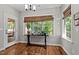 Bright dining area with hardwood floors and large windows overlooking the outdoors at 230 Paddy Ln, Youngsville, NC 27596