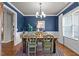Elegant dining room with hardwood floors, wainscoting, and a rustic dining set at 230 Paddy Ln, Youngsville, NC 27596