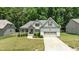 Attractive single Gathering home with inviting front yard landscaping and attached two-car garage at 230 Paddy Ln, Youngsville, NC 27596