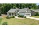 Charming home showcasing a welcoming porch, landscaped front yard, and attached garage at 230 Paddy Ln, Youngsville, NC 27596