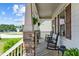 Cozy front porch features rocking chairs, stone columns, and space for relaxing outdoors at 230 Paddy Ln, Youngsville, NC 27596