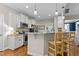 Modern kitchen with granite countertops, stainless steel appliances, and bar seating at 230 Paddy Ln, Youngsville, NC 27596