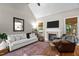Bright living room featuring a fireplace, comfortable seating, and hardwood flooring at 230 Paddy Ln, Youngsville, NC 27596