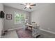 Office space with a large window, desk, printer and patterned rug at 230 Paddy Ln, Youngsville, NC 27596
