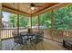 Screened porch with wood ceiling and a metal table and chairs set at 230 Paddy Ln, Youngsville, NC 27596