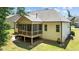 Rear view of home featuring a screened porch and tidy yard with landscaping at 230 Paddy Ln, Youngsville, NC 27596