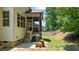 Backyard showing porch access and a grill with potted plants on a concrete pad at 230 Paddy Ln, Youngsville, NC 27596