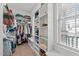 Walk-in closet featuring built-in shelving and storage, with a window offering natural light at 230 Paddy Ln, Youngsville, NC 27596