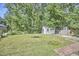 Wide angle of the backyard, with a shed and partial fencing at 2616 Kirk Rd, Durham, NC 27705