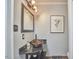 Chic powder room has a unique bowl sink, framed art, and decorative lighting at 2616 Kirk Rd, Durham, NC 27705
